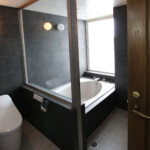 タイルオンタイル工法を用い既存のバスユニットをそのままに、シックな雰囲気漂う空間に。